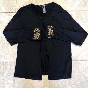 Ellen Tracy black sweater w/embroidered sleeves. 1 button on top. Extra button